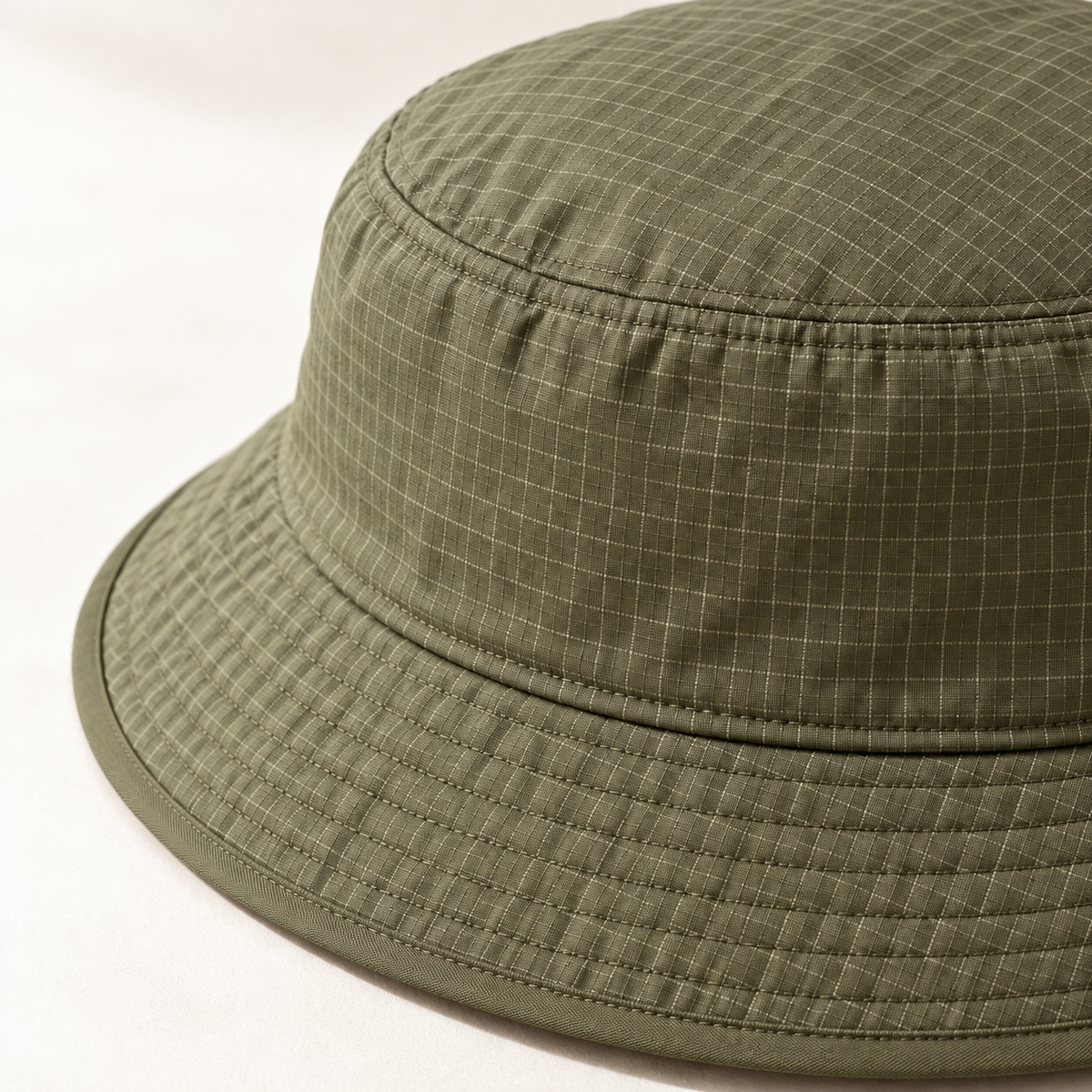 Grove Ripstop Bucket in moss: surface and stitching detail